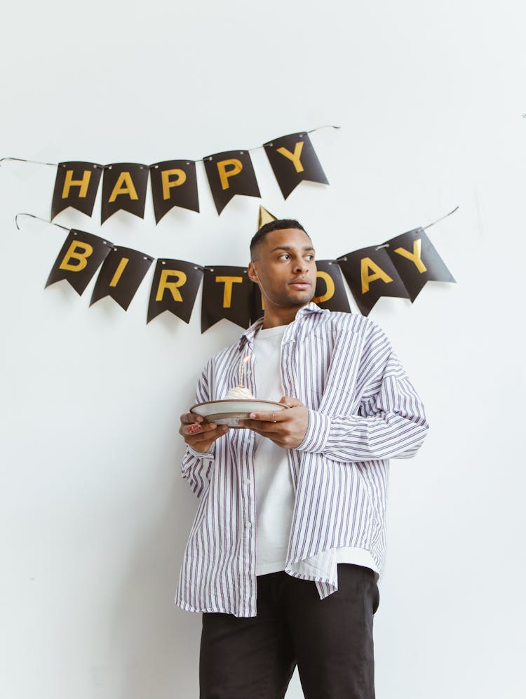 Man Holding A Plate With Cake