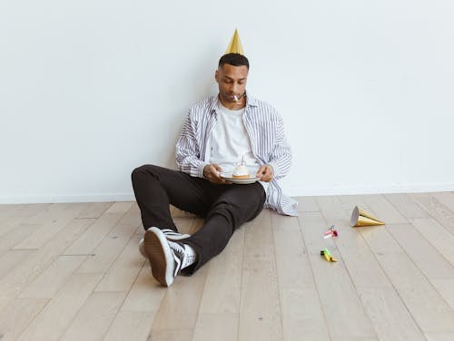 Man Holding a Plate with Cake