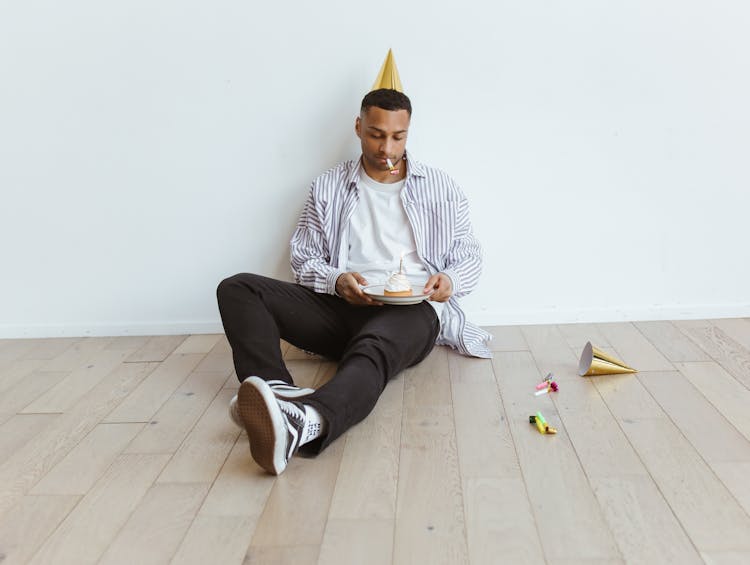 Man Holding A Plate With Cake