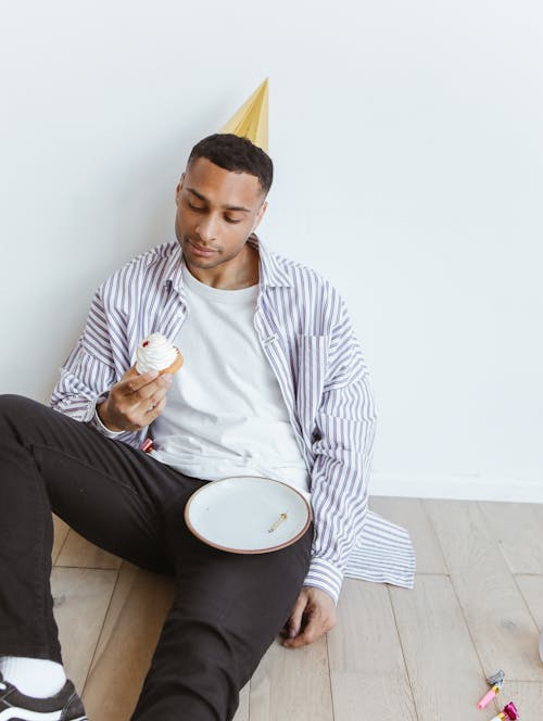 Man Holding a Small Cake