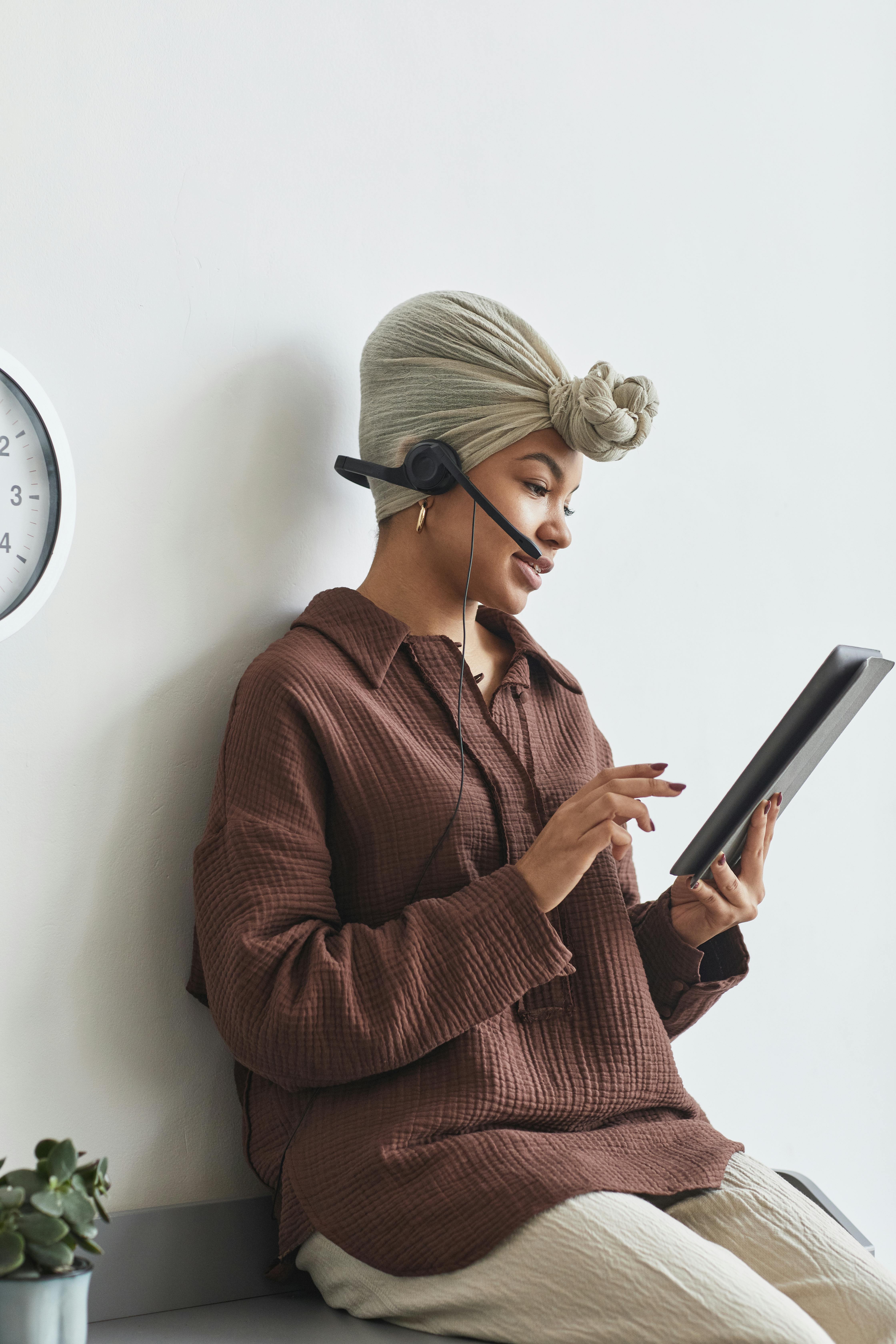 black woman with handsfree headset and tablet