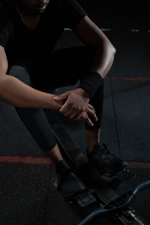 Free A Man in Black Activewear Resting Stock Photo