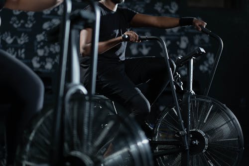 Person in Black Activewear Using a Stationary Bicycle