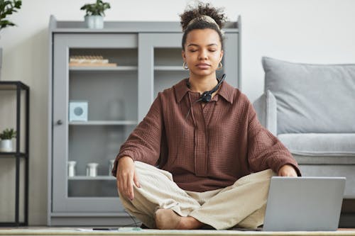 Free Woman in Brown Top Meditating Stock Photo