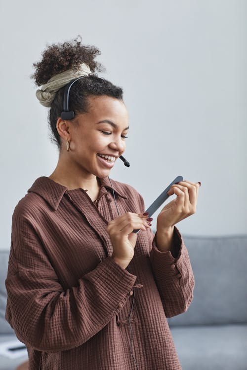 A Female Call Center Agent Using a Nail File