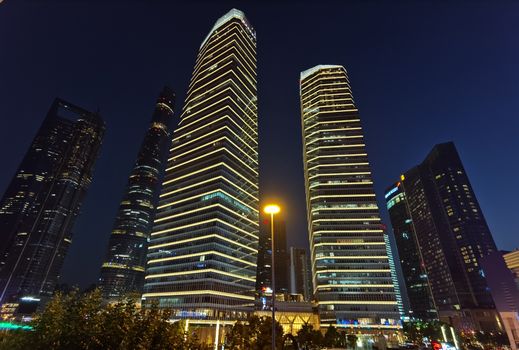 Stunning night view of illuminated skyscrapers in Shanghai's urban skyline.