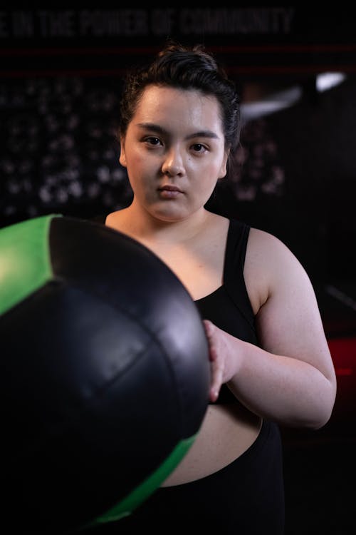 Woman Holding a Medicine Ball