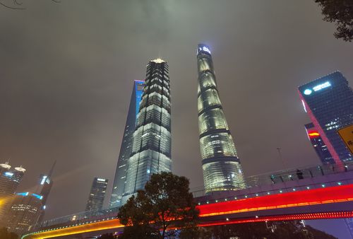 Free Stunning view of Shanghai skyscrapers illuminated against a cloudy night sky. Stock Photo