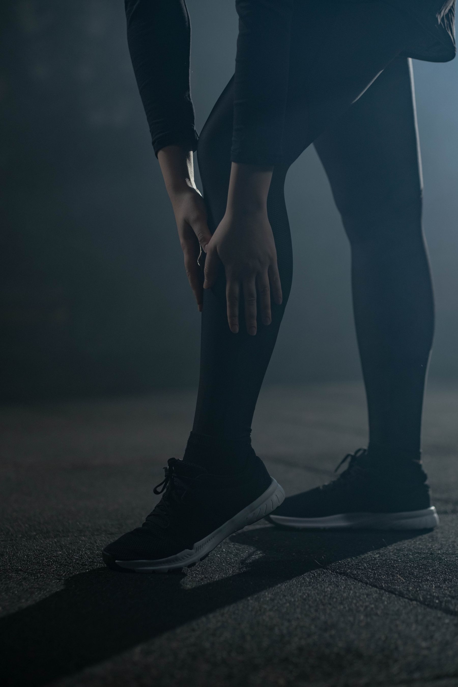 Athlete stretching in dark performance apparel