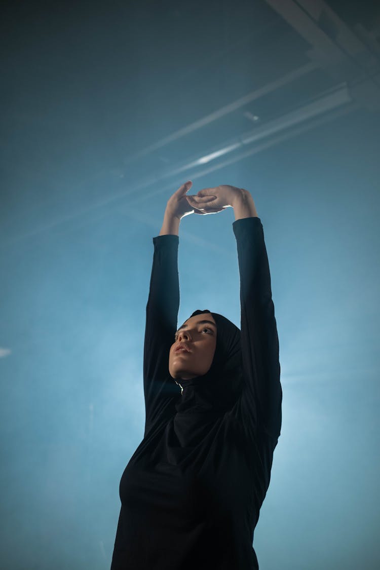 Woman In Black Activewear Exercising