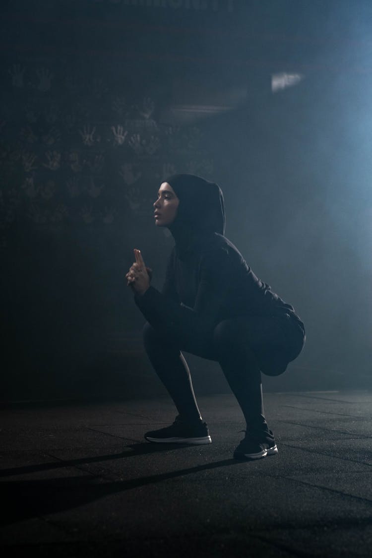 Woman In Black Activewear Exercising