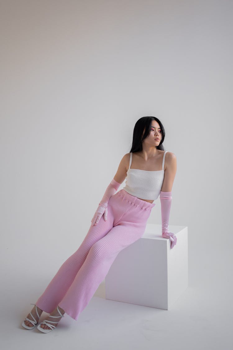 A Woman Sitting On A Wooden Block