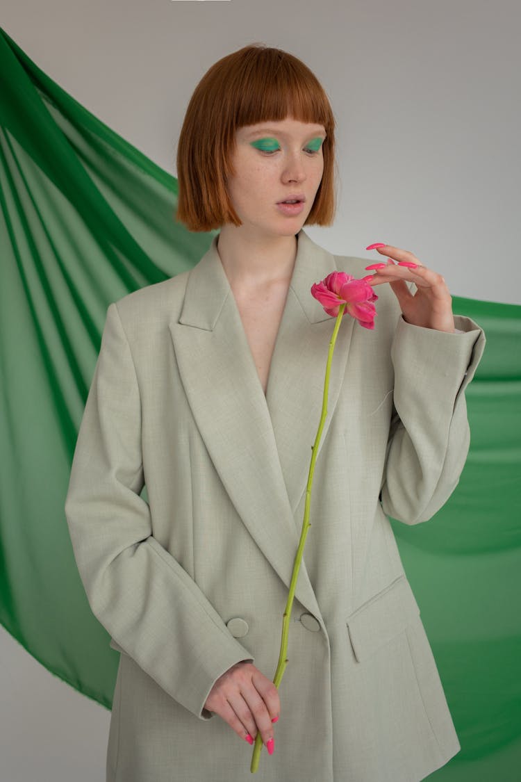 Stylish Woman With Flower In Studio