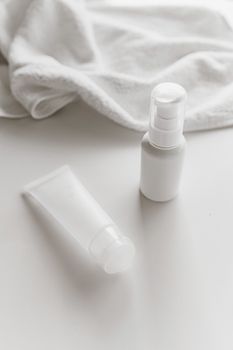 Elegant white skincare products set on a clean, minimalist background perfect for advertising.