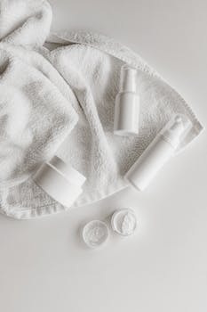 Elegant display of skincare products on a white towel, ideal for beauty enthusiasts.