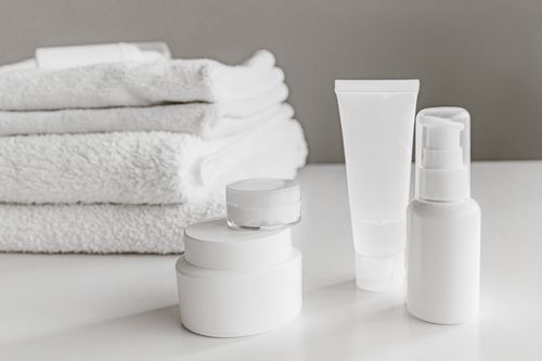 Minimalist white skincare bottles — photo by Roman Odintsov on Pexels