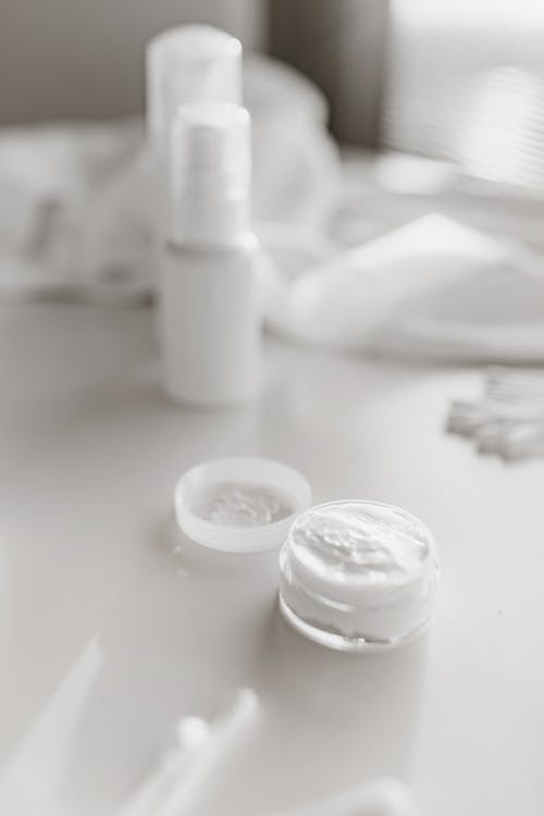Facial Cream in Clear Glass Container with Plastic Lid