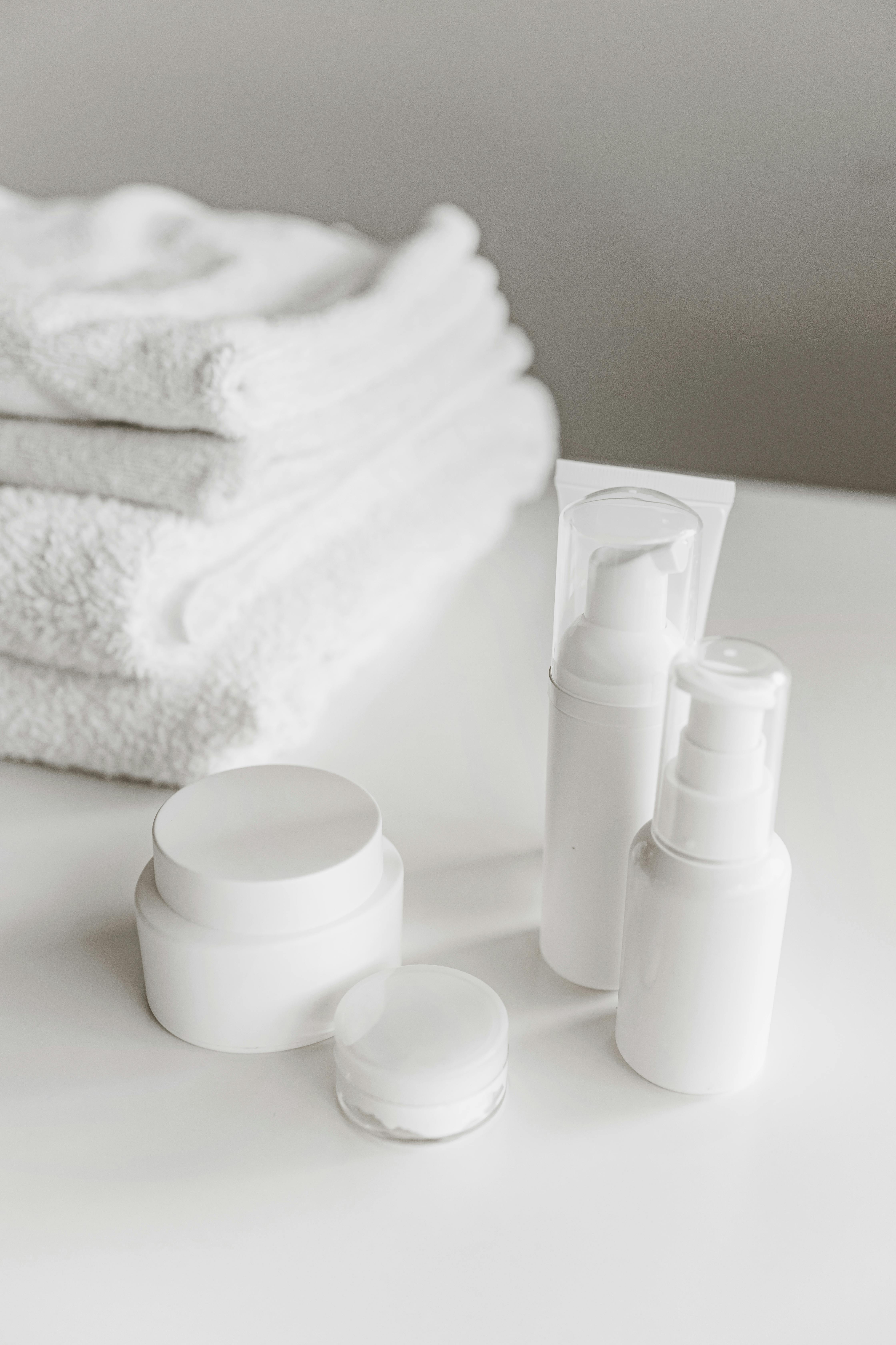 beauty products beside white towels