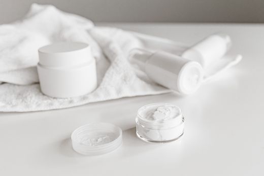 Unbranded white cosmetics jars and tubes — photo by Roman Odintsov on Pexels