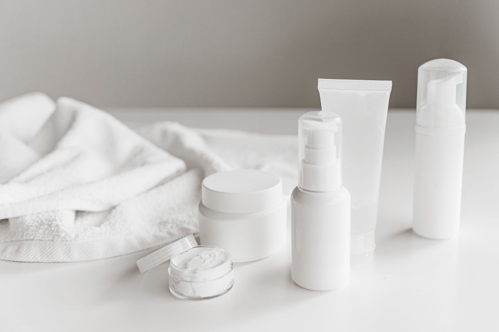 Clean display of unbranded white skincare products — the starting point for building your own health and beauty brand