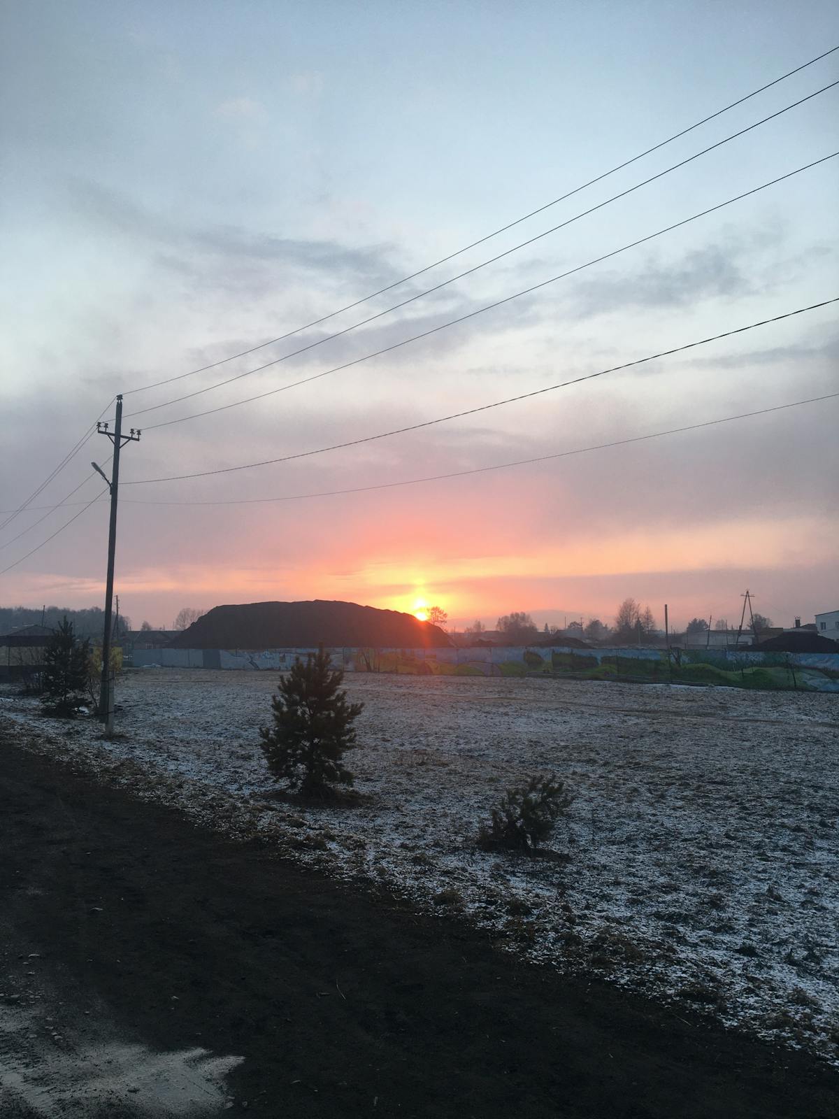 Person watching news clips on a smartphone in a dimly lit room