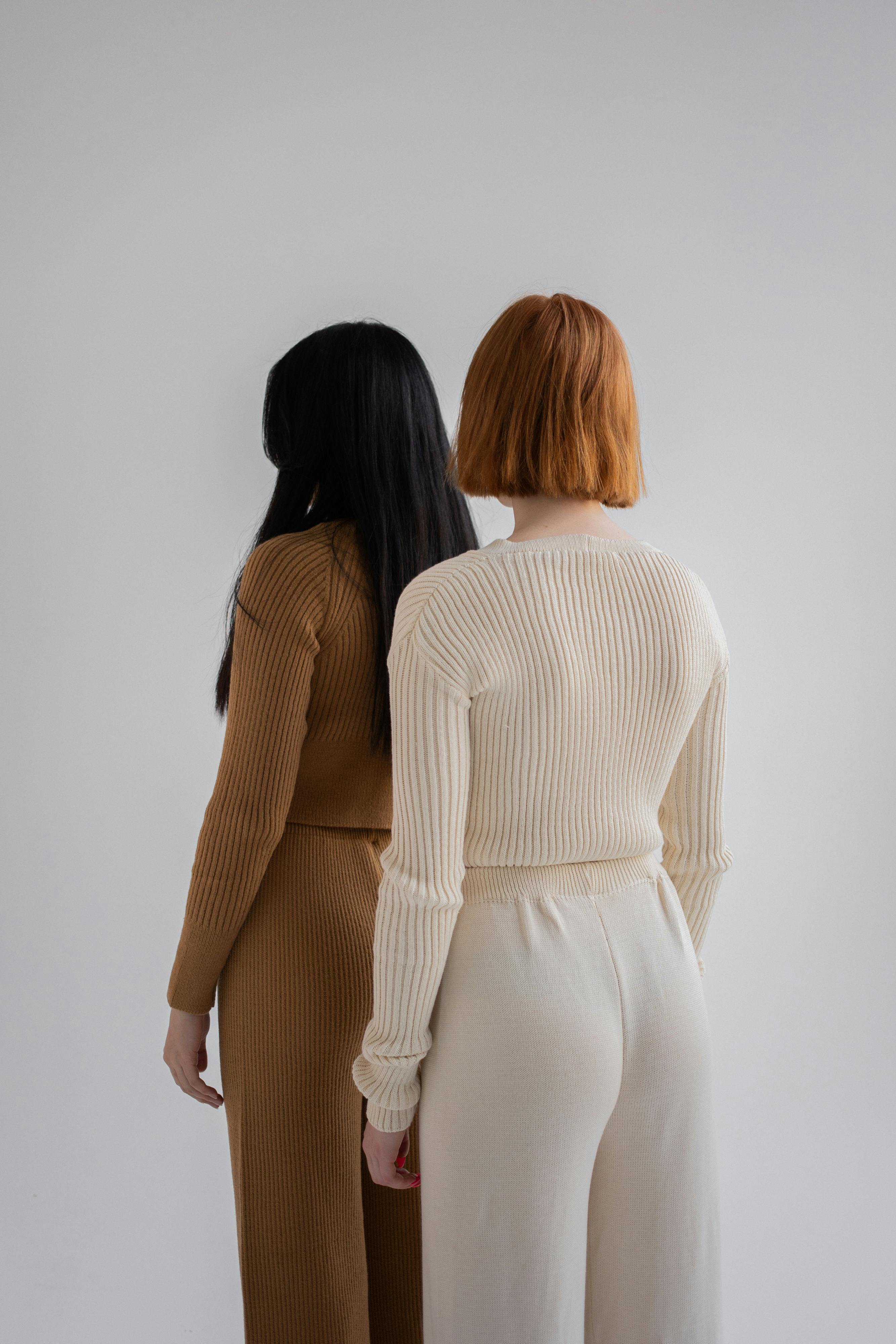 women dressed in knitted sweaters and pants in studio