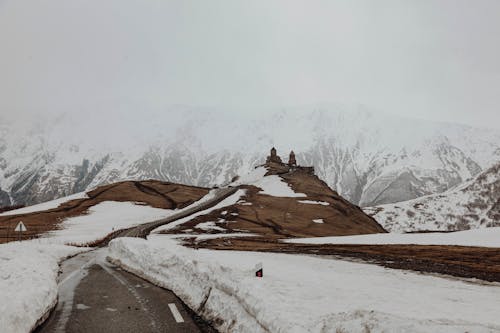 Fog and Snow around Road in Mountains