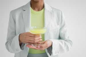 Crop black woman with glass of cocktail