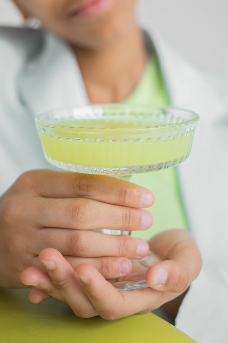 Black Woman With Vintage Glass With Light Yellow Drink