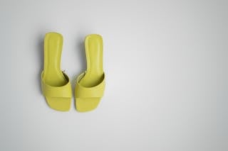 Stylish pair of female mule shoes on light background