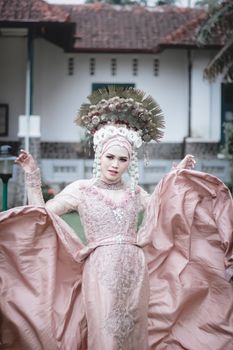 Stunning portrait of a woman in traditional bridal attire with intricate lace and headdress.