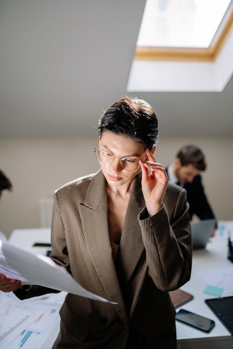 A Close-Up Shot Of A Woman Reading A Document