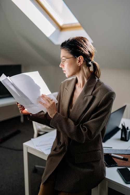 A Woman in Corporate Attire Reading Files