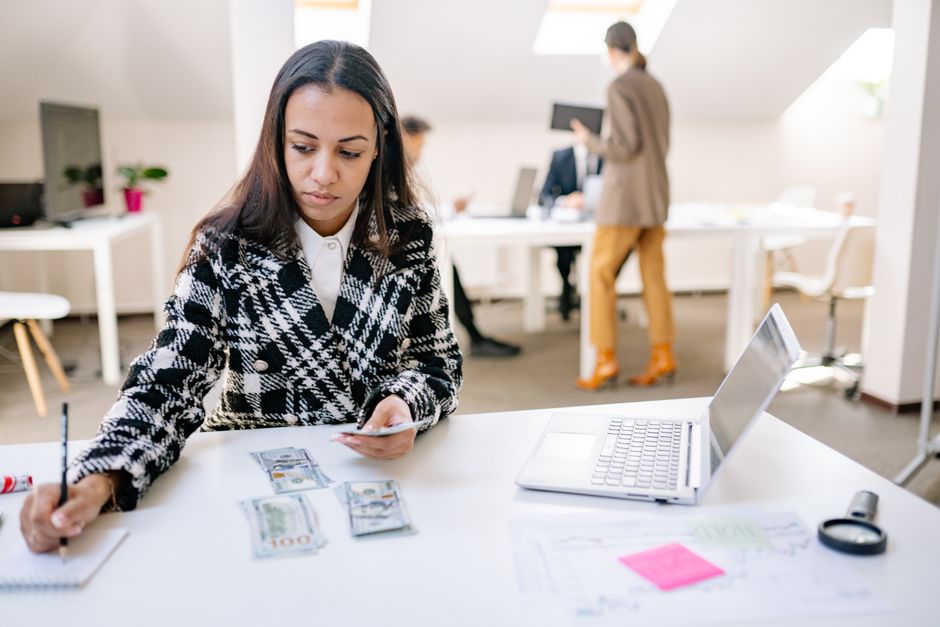 professional woman working at bank desk with computer