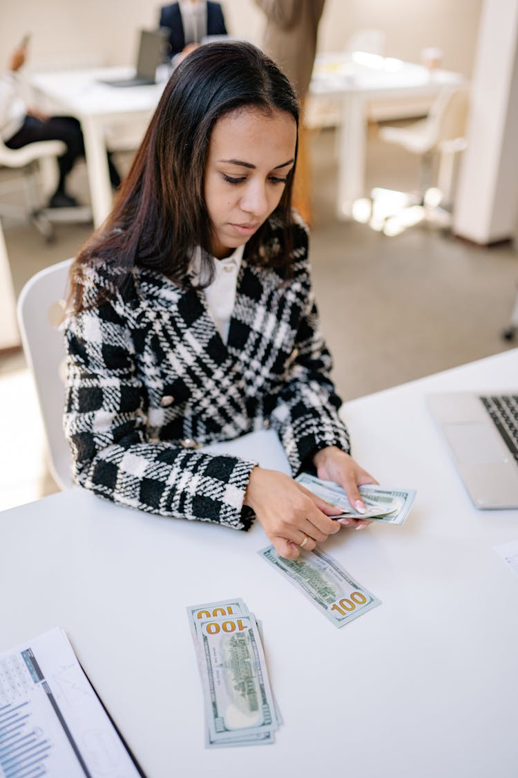 Woman Counting Cash On White Table