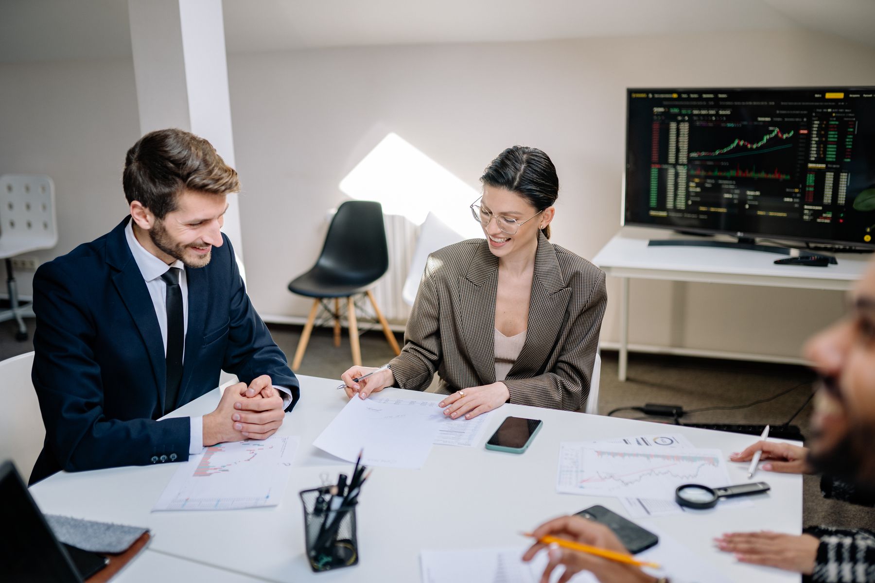 Executives reviewing market data and growth charts during a strategy meeting
