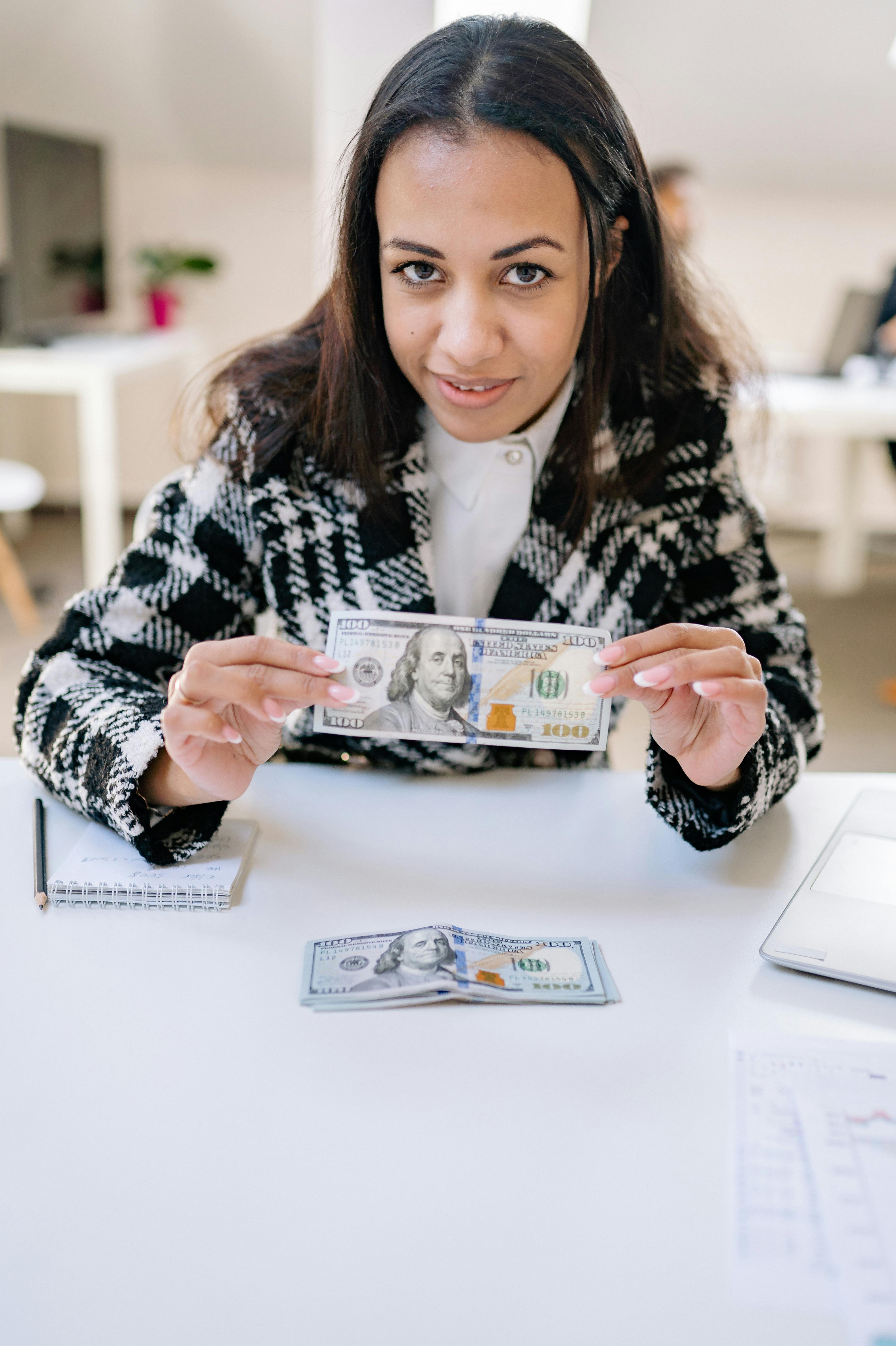 selective focus of a woman holding paper money