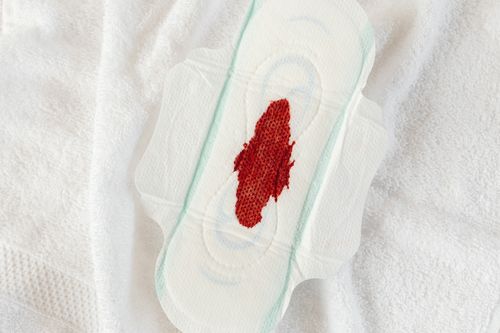 Free Detailed view of a sanitary pad with a blood stain, highlighting menstruation theme. Stock Photo