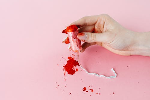 Free Photo of a Tampon With Blood Stains Being Held Stock Photo