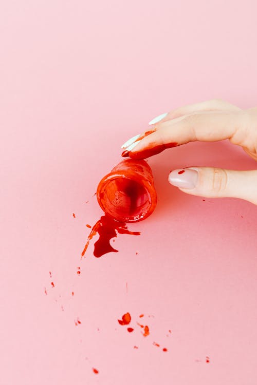 Close-Up Shot of a Person Holding a Menstrual Cup with Blood