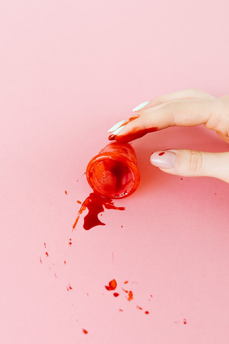 Close-Up Shot Of A Person Holding A Menstrual Cup With Blood