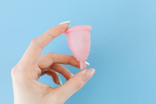 A Hand Holding a Menstrual Cup