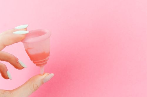 Free Close-up of a menstrual cup on a pink background, highlighting menstrual care. Stock Photo