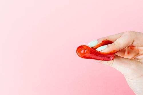 Free Close-up of a hand with a menstrual cup, illustrating menstrual themes with a vivid background. Stock Photo