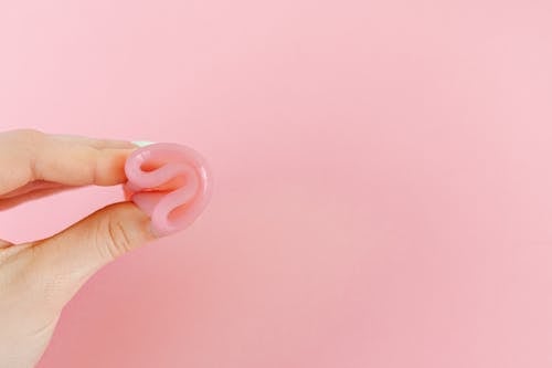 Person Holding Pink Heart Ornament