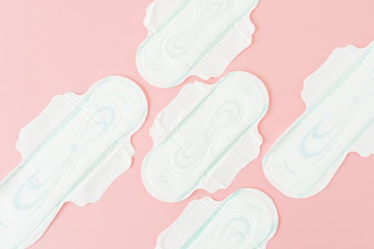 Close-up of sanitary pads arranged on a pink backdrop, highlighting hygiene.