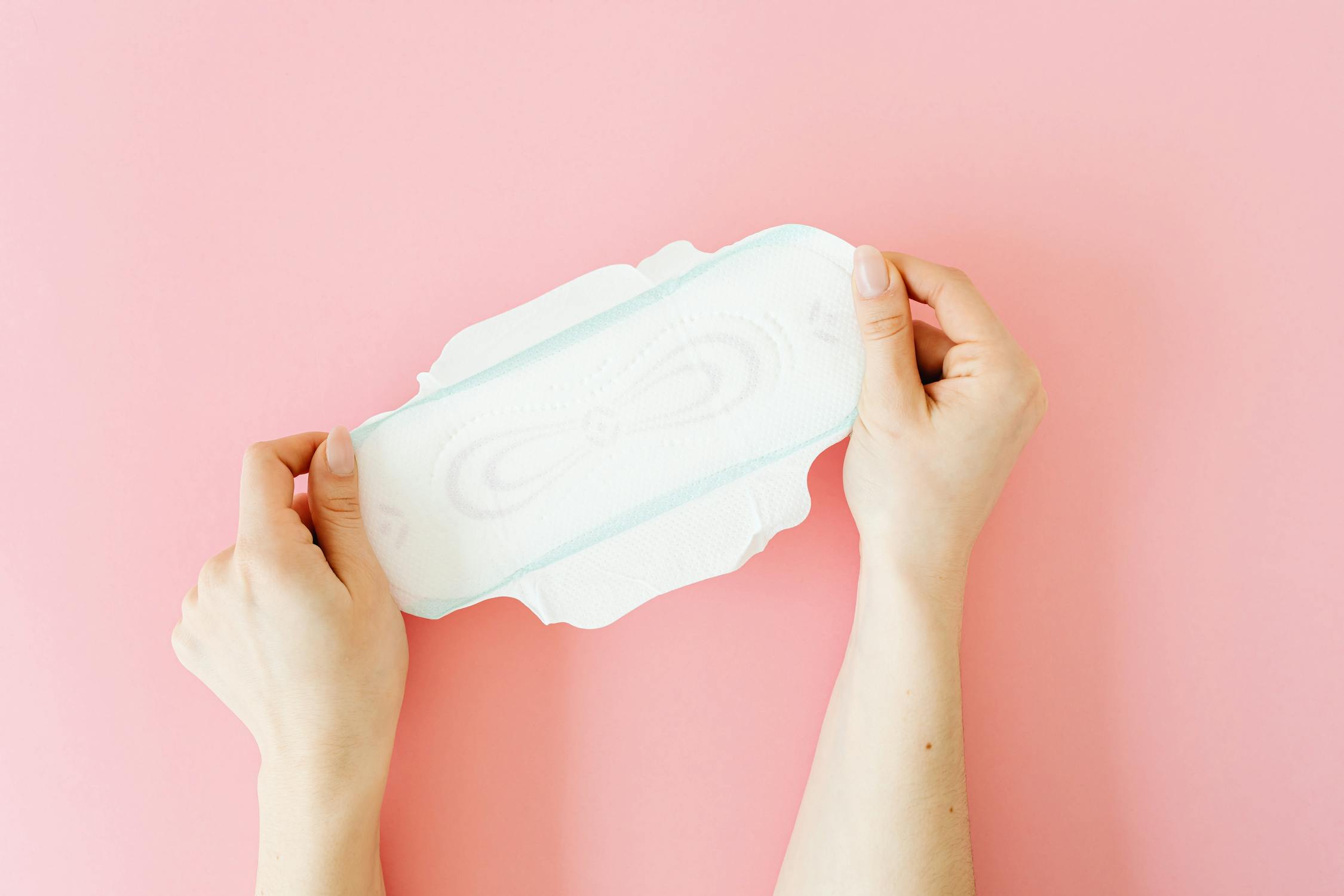 a lady holding a sanitary napkin