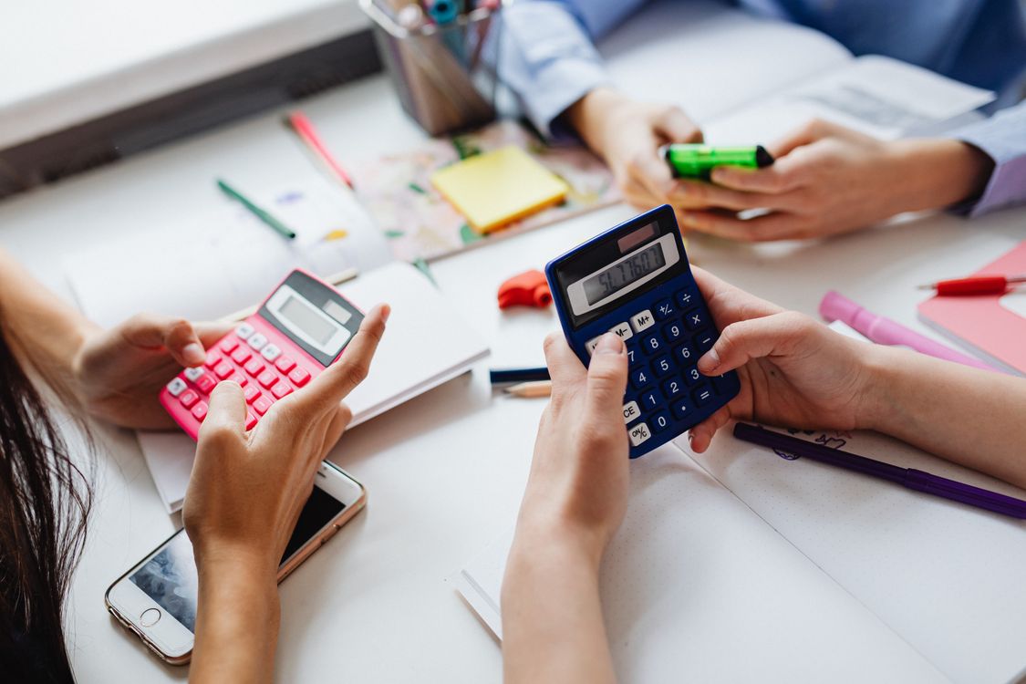 Students using AI tools for math homework on laptops and calculators