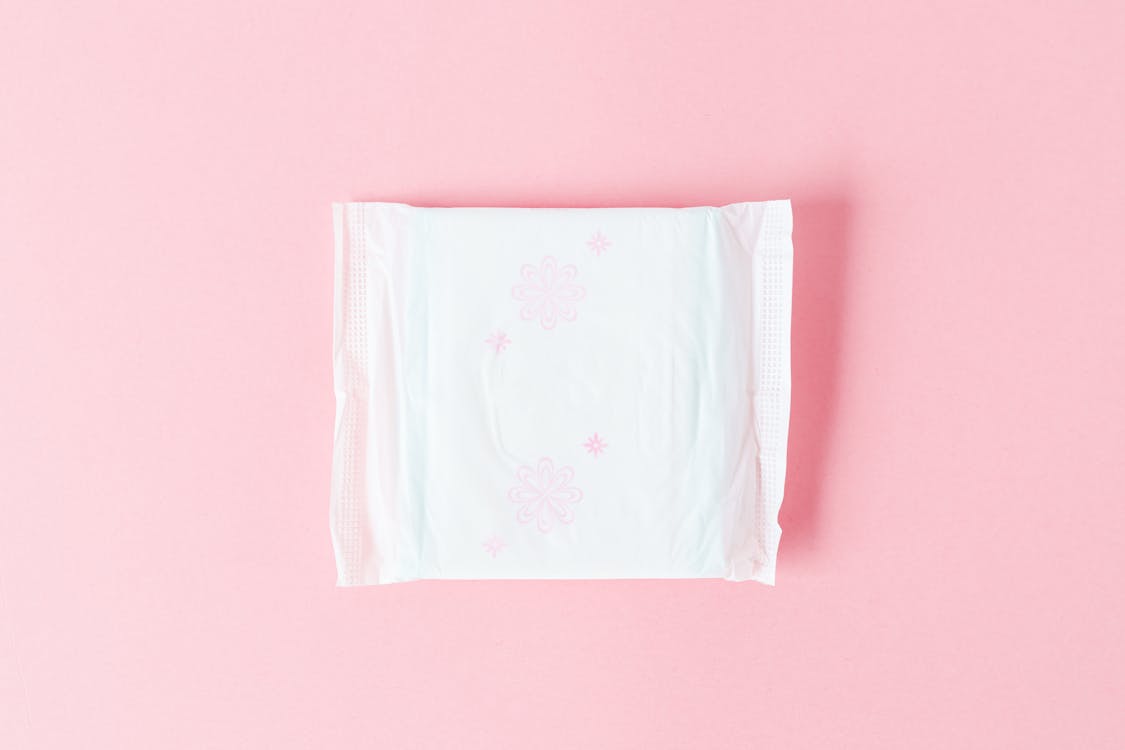 White Sanitary Napkin on Pink Background