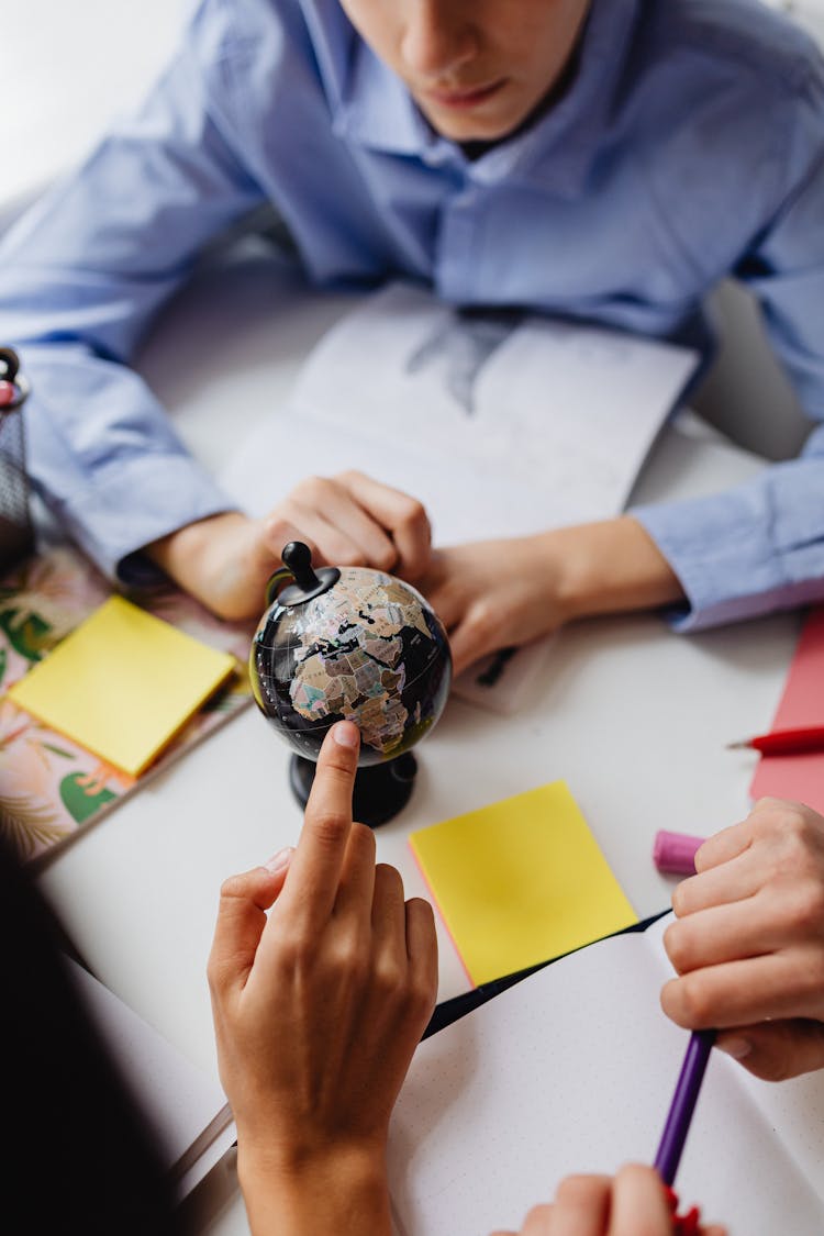 Students Studying A Globe